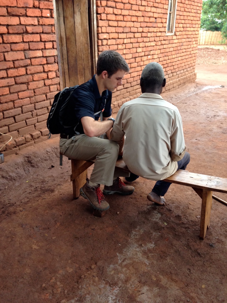 Mike working with a patient in the village. 