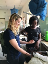 Alycia and our Malawian physio student friend working in the male surgical ward.